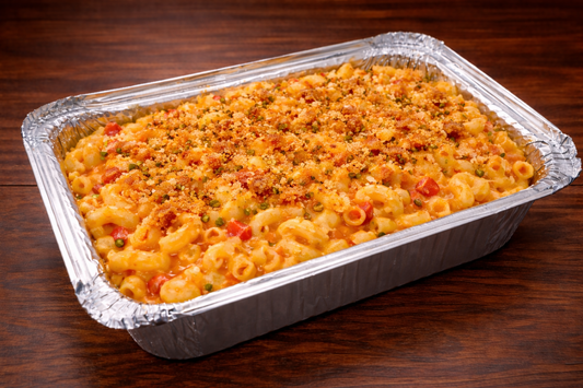 Pimento Macaroni and cheese dish in a foil pan on a wooden surface
